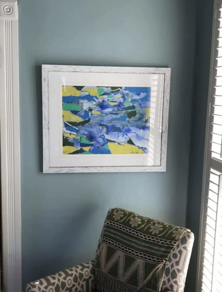 Artwork by Anne custom blue and yellow painting hanging in a home