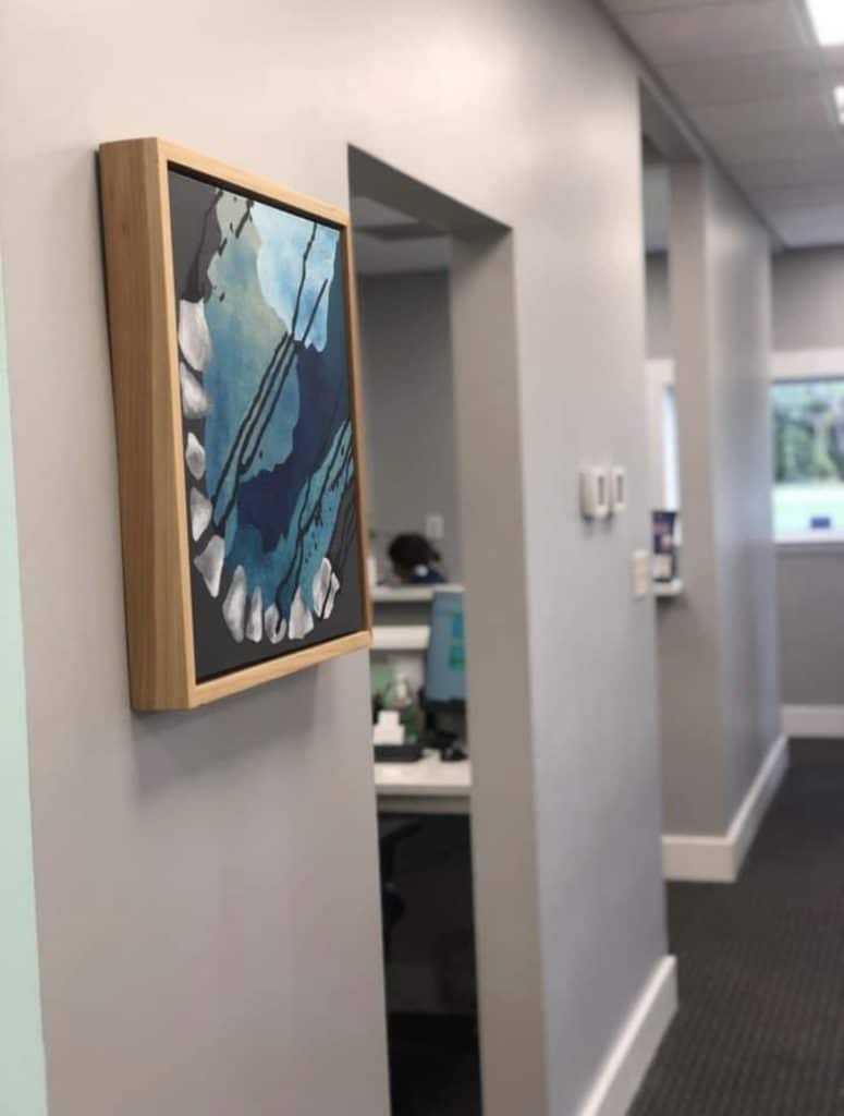 Artwork by Anne blue painting hanging in a home