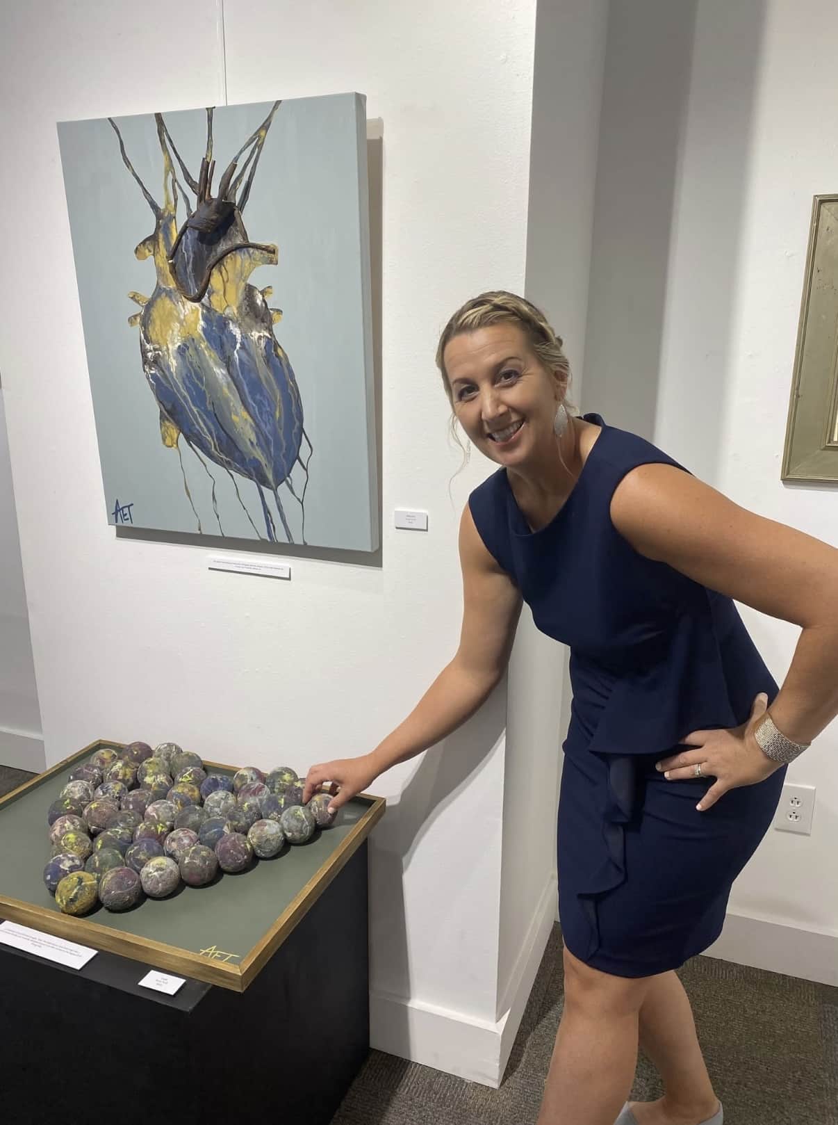 Anne Elsea (now Anne Thrift) local artist posing with her custom artwork